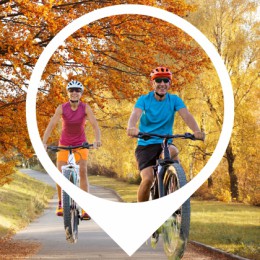 a man and a woman riding bikes