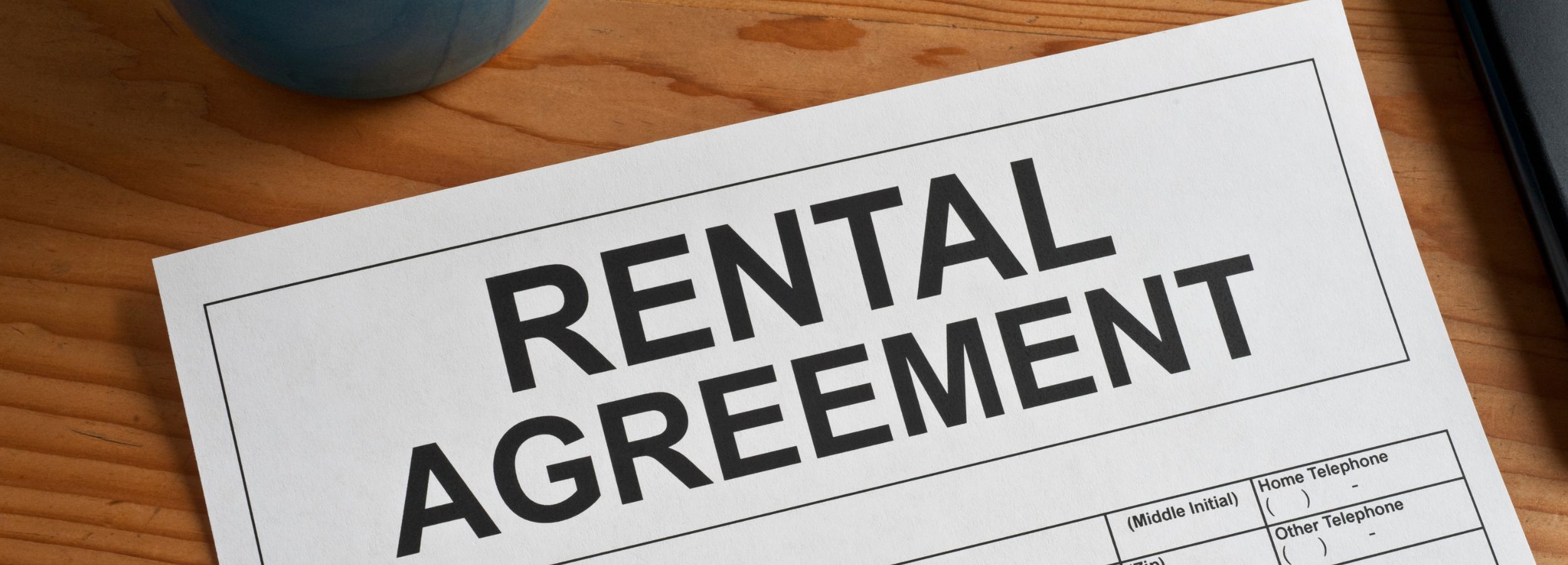 black pen with a piece of white paper that says rental agreement