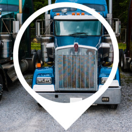 three semi trucks parked in a row