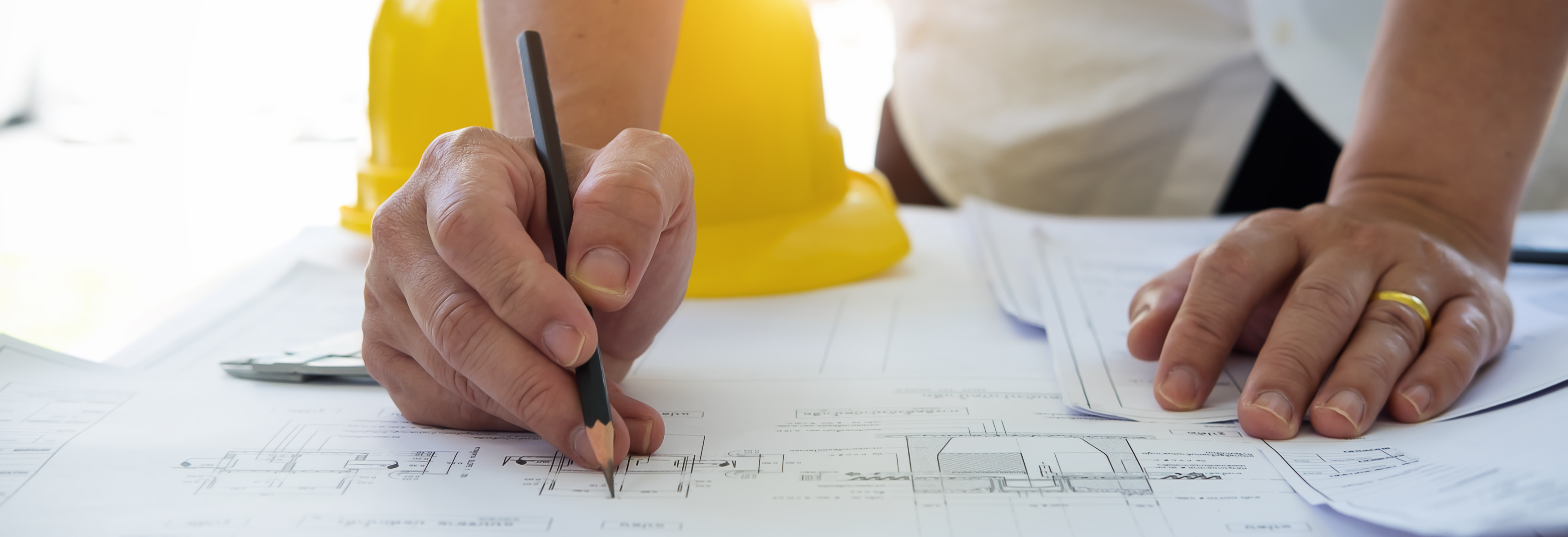 contractor writing on blueprint