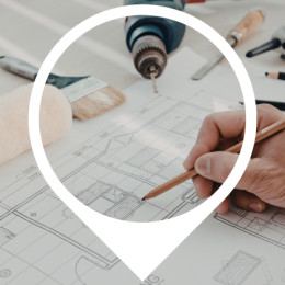 house floor plan with a hand holding a pencil